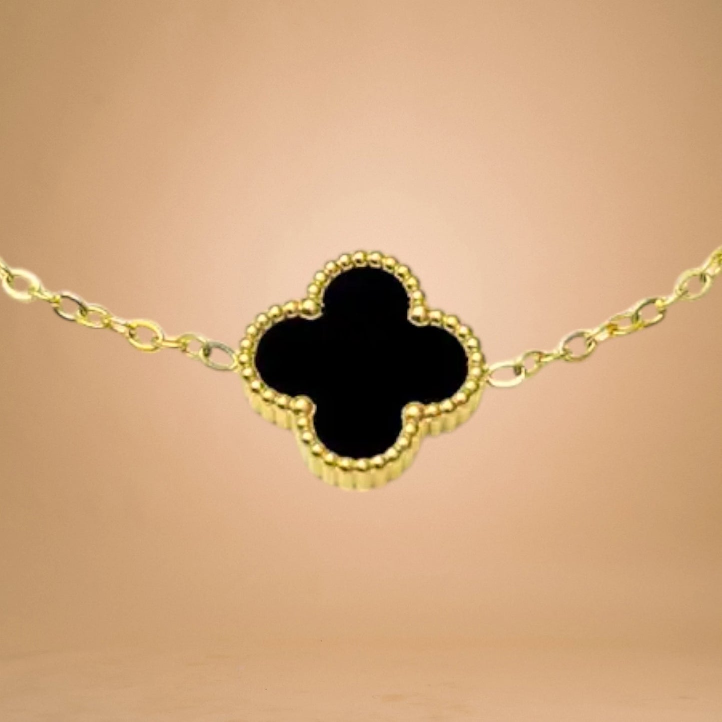 Bracelet zoom-in shot displayed on a peach-toned background.