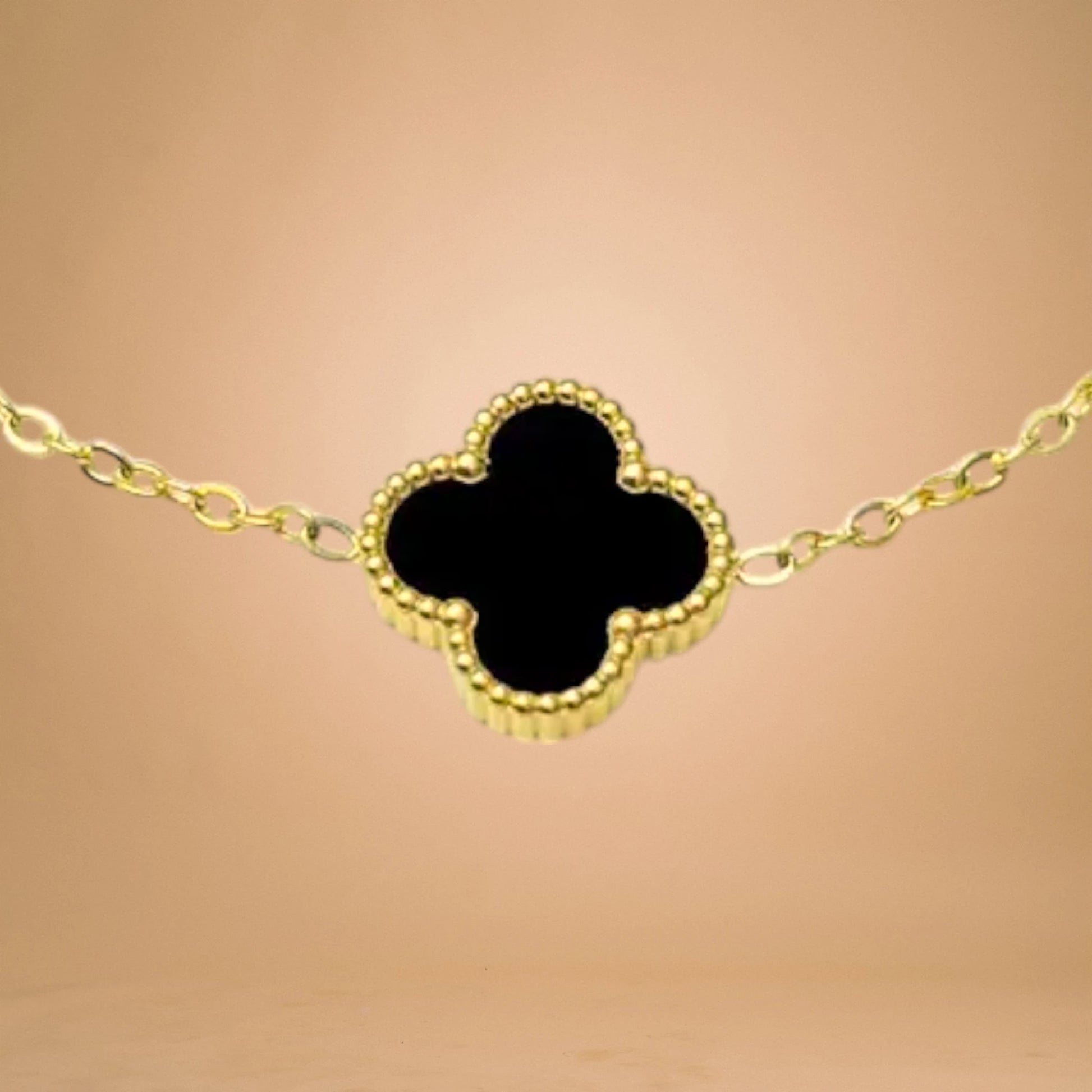 Bracelet zoom-in shot displayed on a peach-toned background.