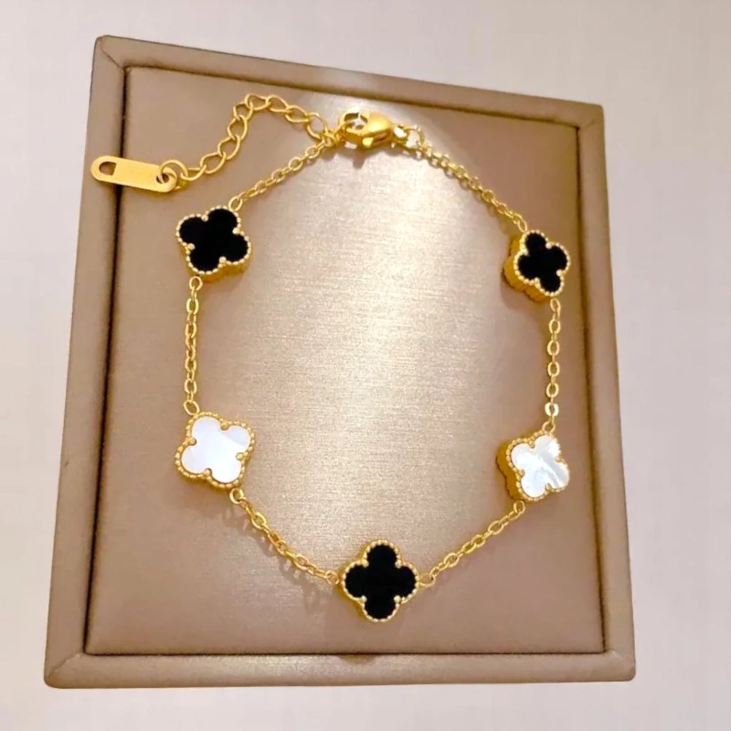 Bracelet on soft fabric box with a light toned background.