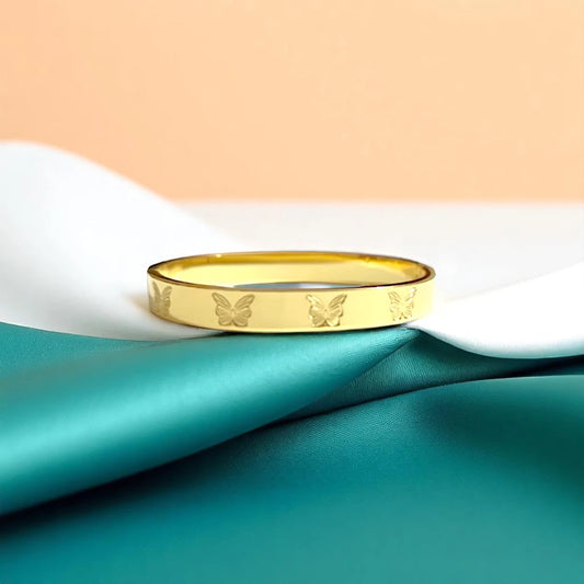 Bracelet set against a soft teal cloth background.