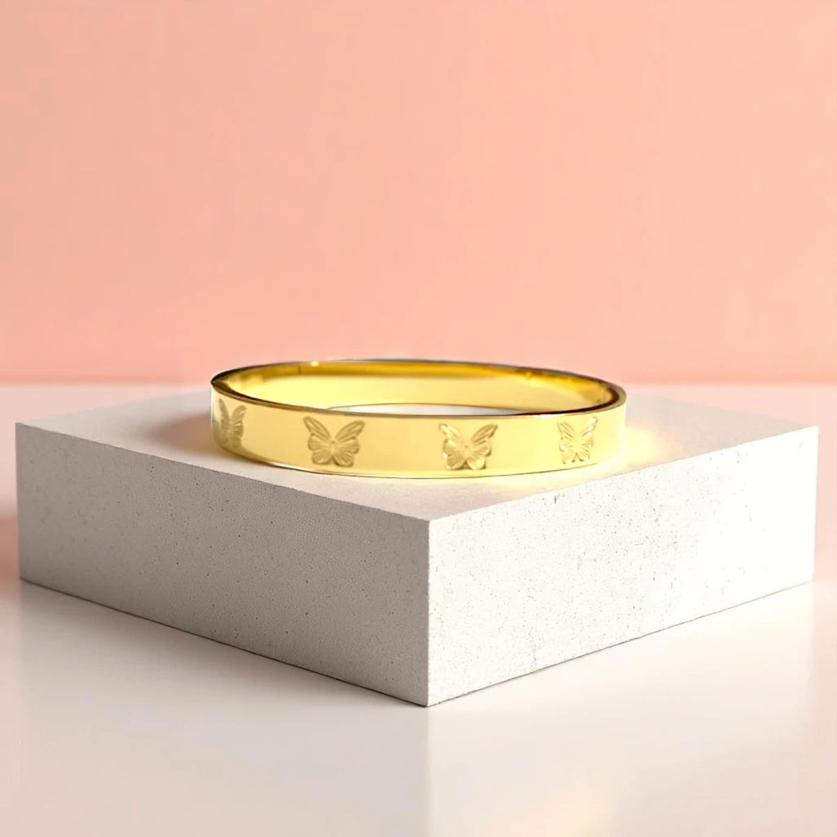 Bracelet displayed on a light-colored travertine stone slab with a peach-colored gradient in the background.
