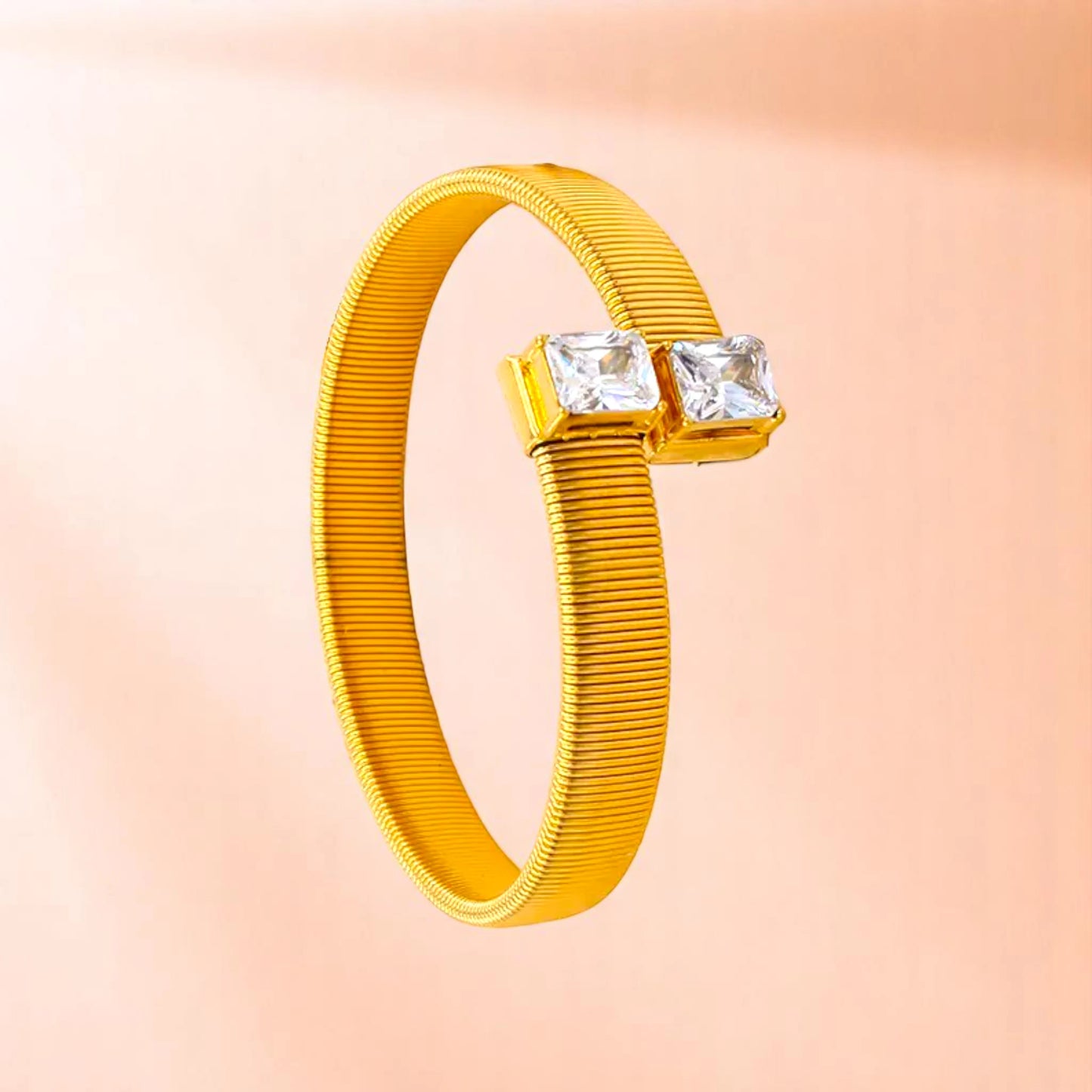 Bracelet on a color gradient of peach tones background.