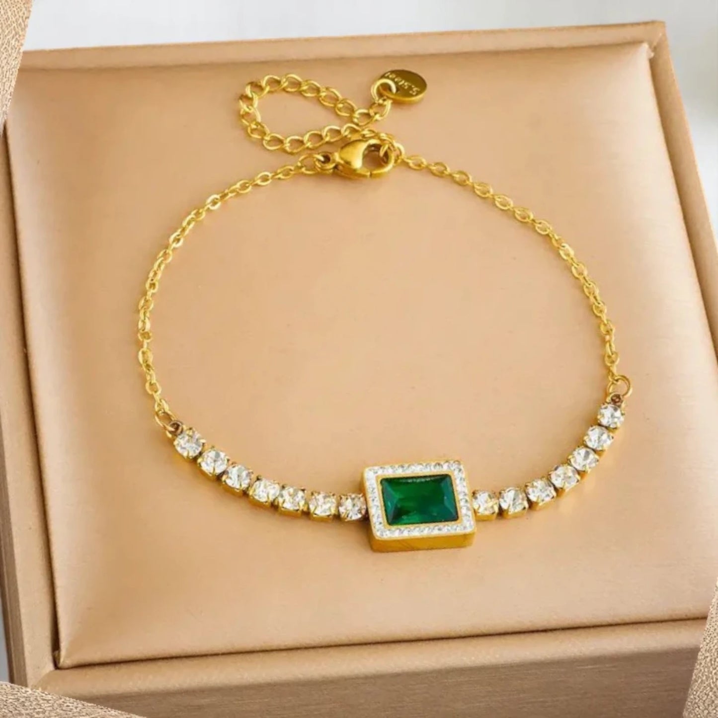 Bracelet on soft fabric box with a light toned background.