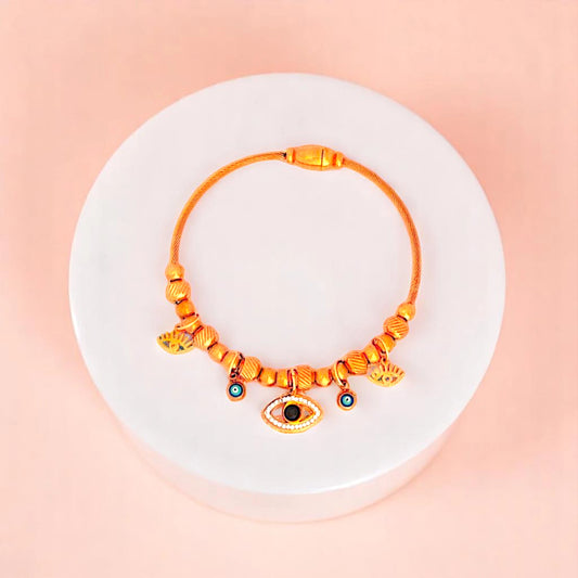 Bracelet on geometric prop with peach color gradient in the background.