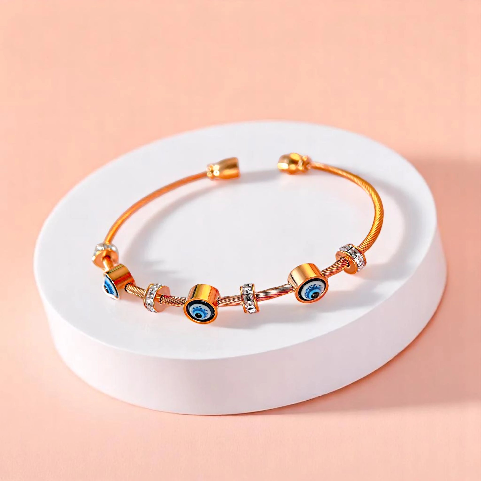 Bracelet on geometric prop with peach color gradient in the background.