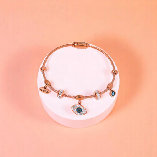 Bracelet on geometric prop with peach color gradient in the background.