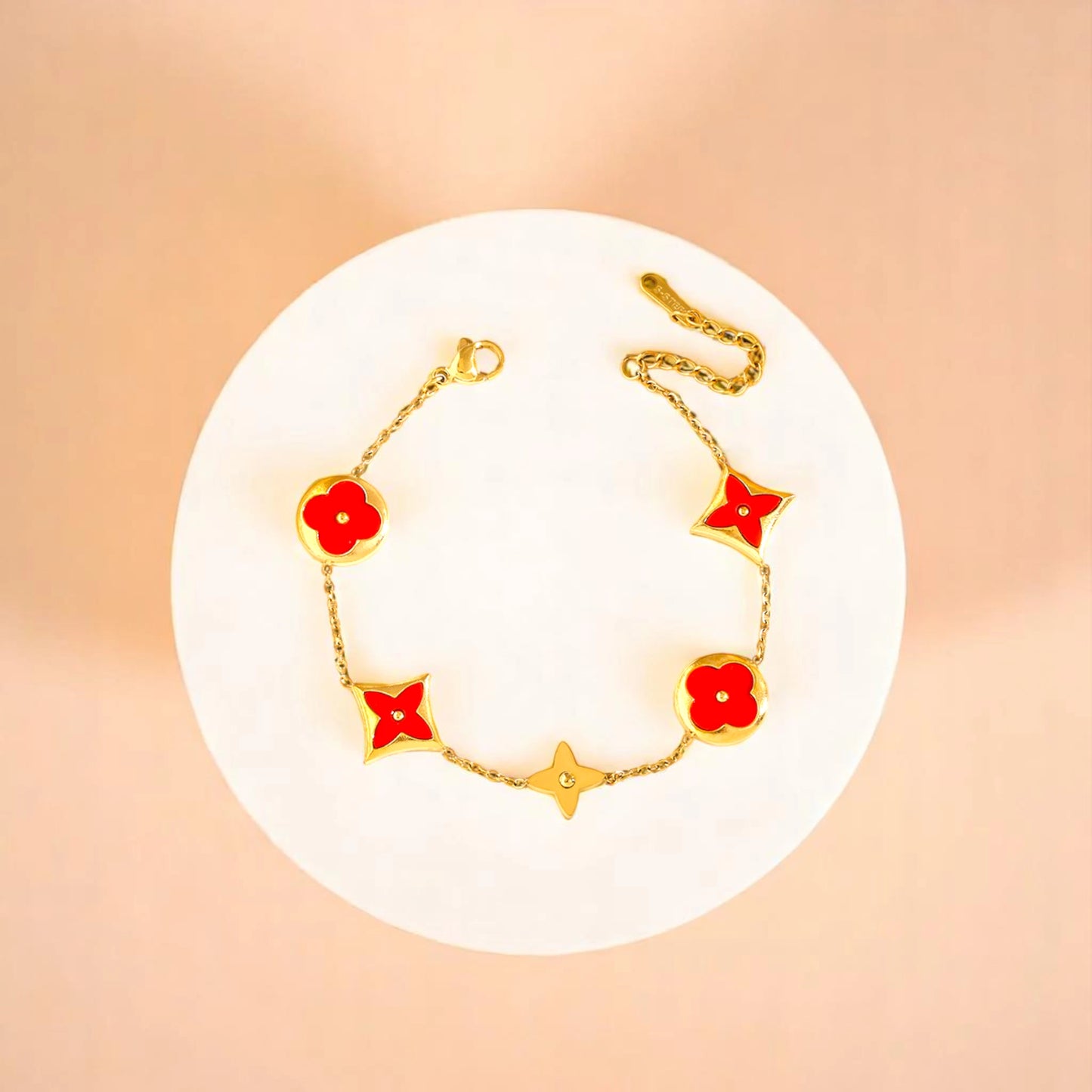 Bracelet on geometric prop with peach color gradient in the background.