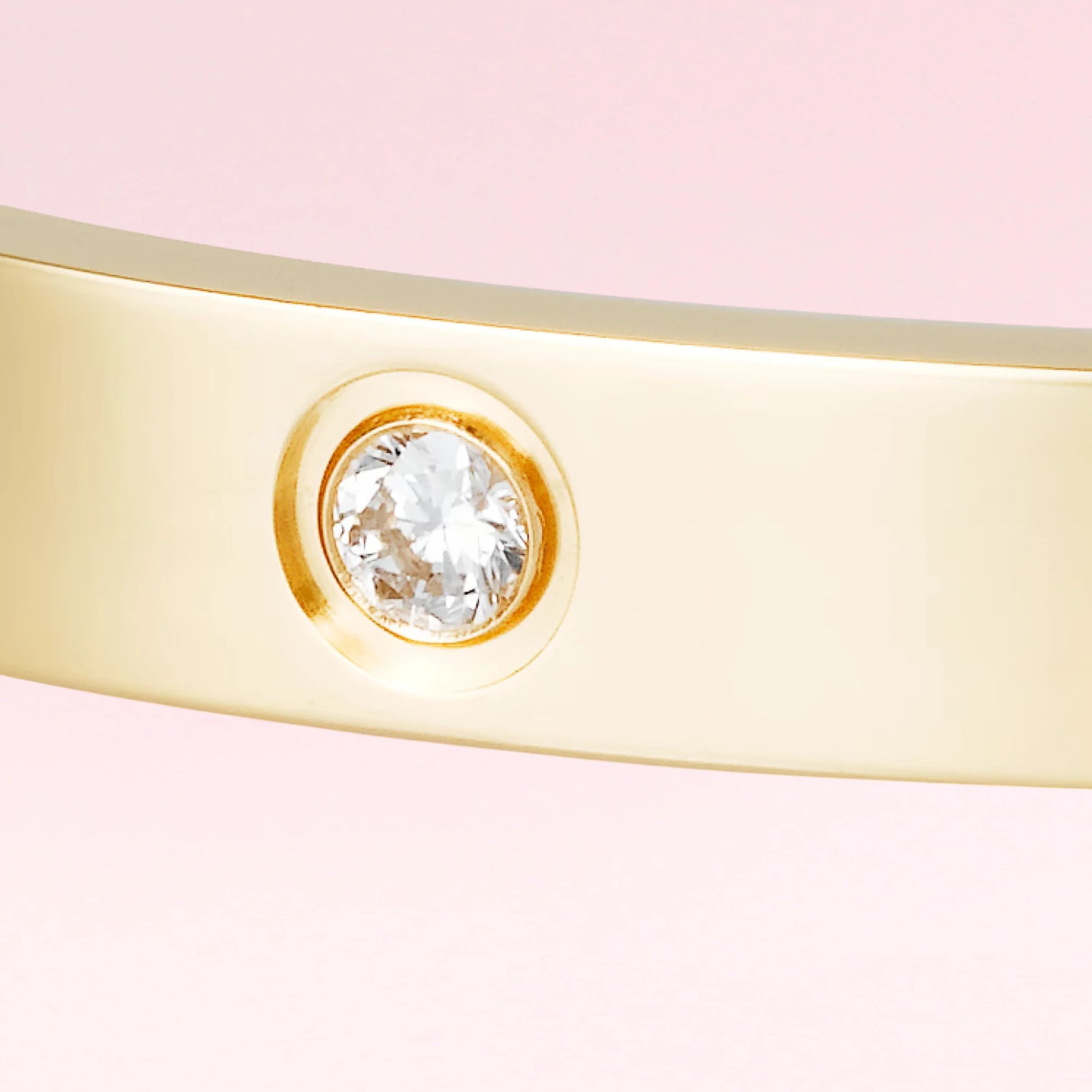 Crystal setting close-up on a bracelet on a color gradient of light tones background.