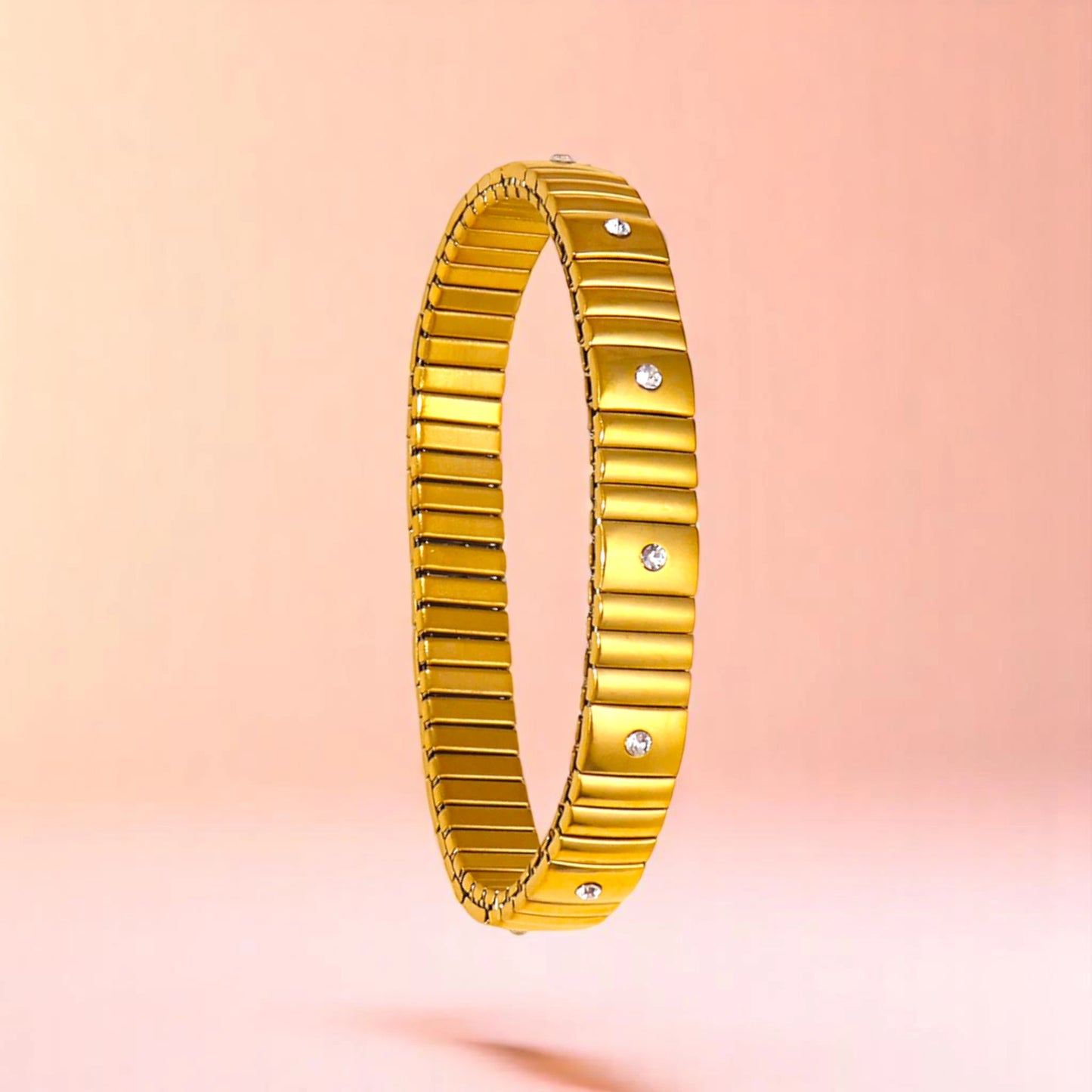 Bracelet on a color gradient of peach tones background.