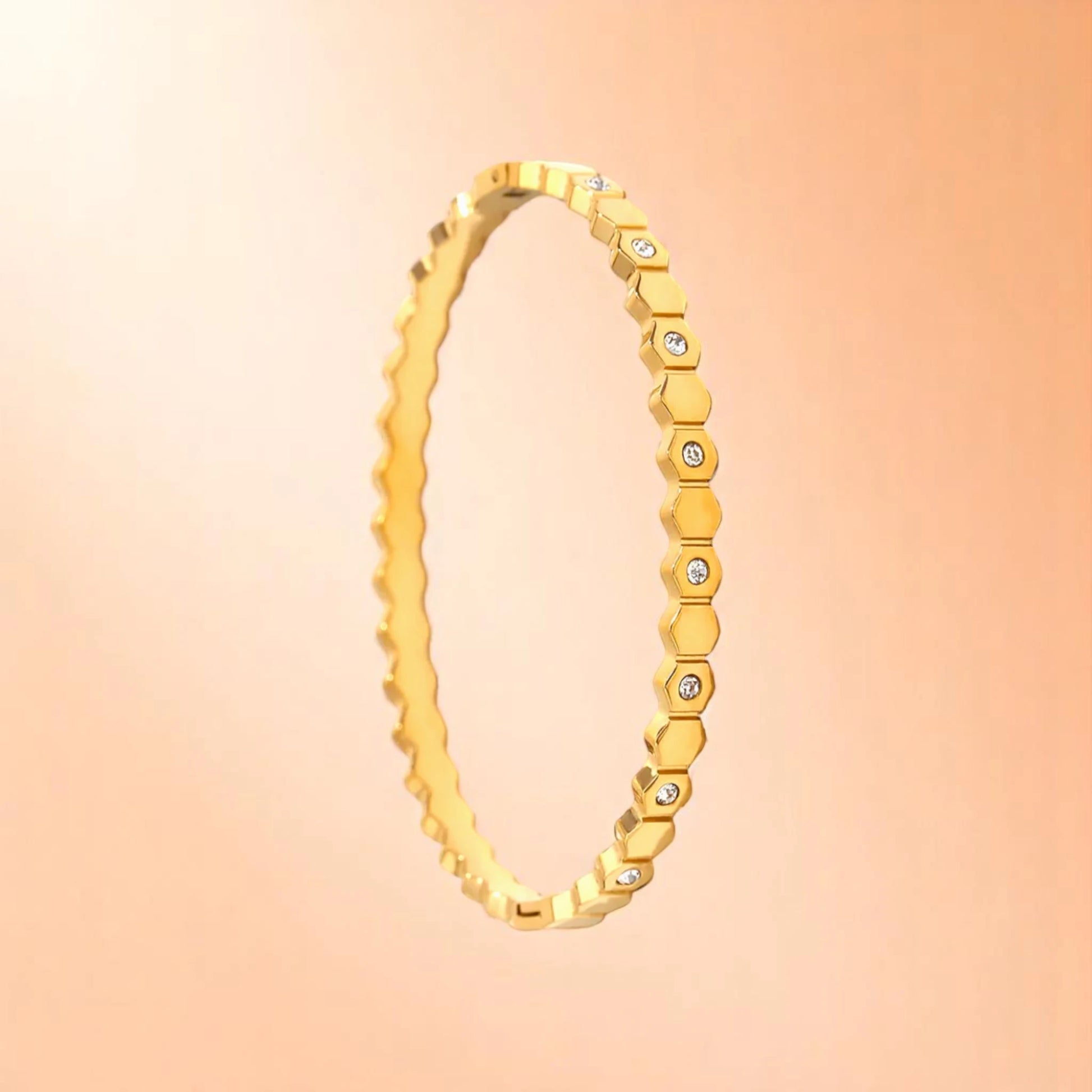 Bracelet on a color gradient of peach tones background.
