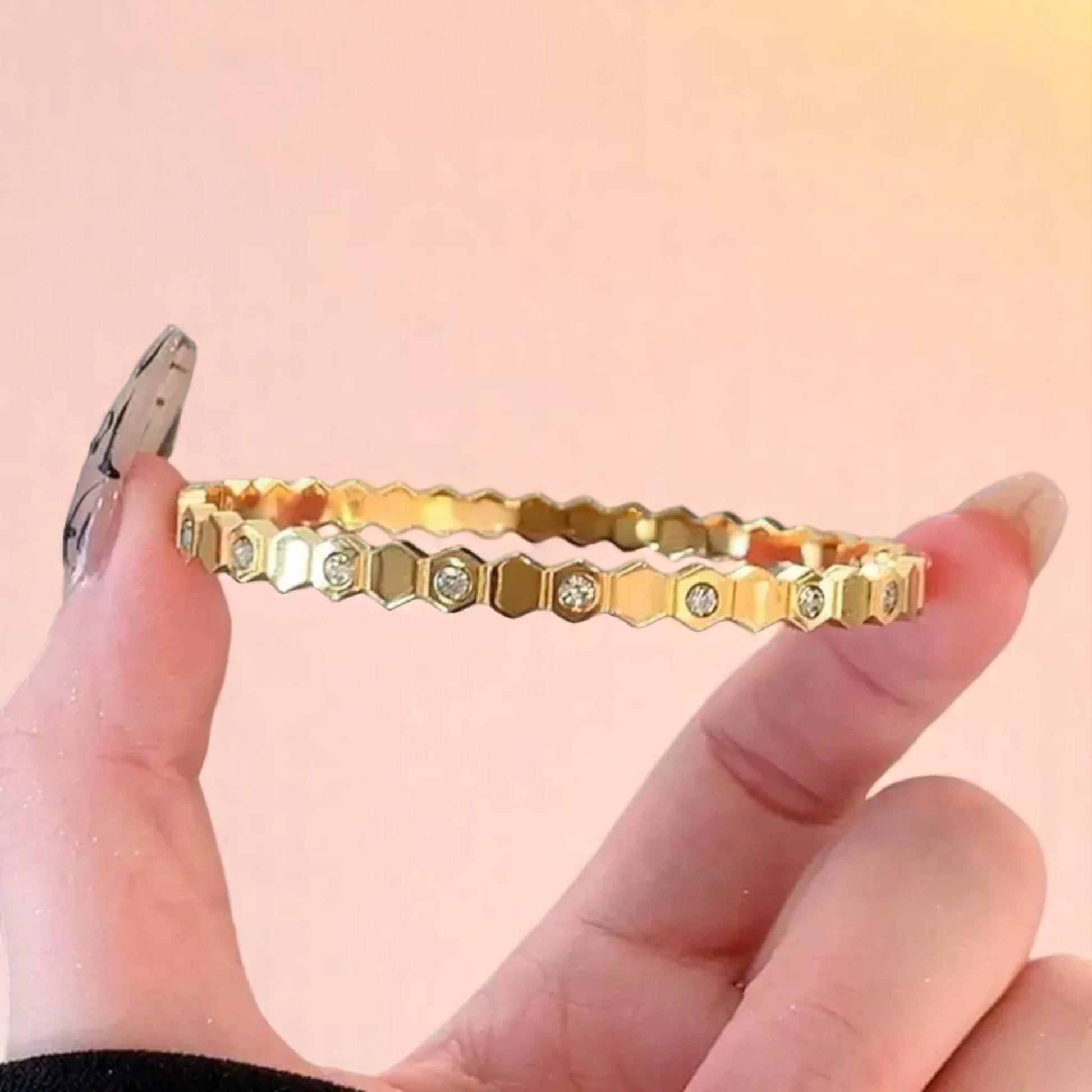 Model holding a bracelet.