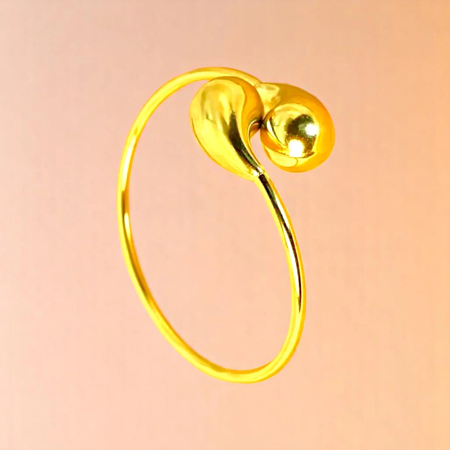 Bracelet on a color gradient of peach tones background.