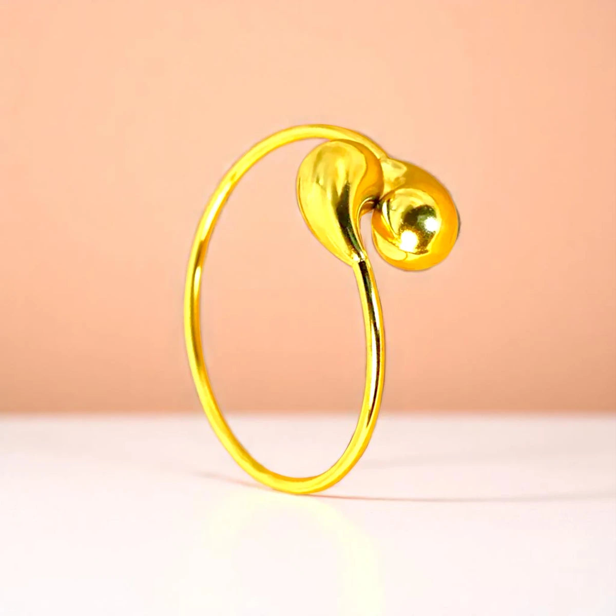 Bracelet on a color gradient of peach tones background.