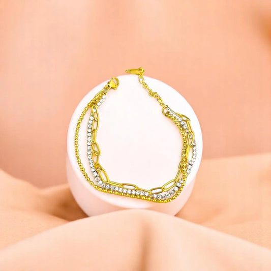 Bracelet on geometric prop with peach color gradient in the background.