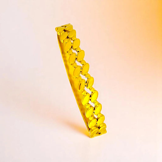 Bracelet on a color gradient of peach tones background.