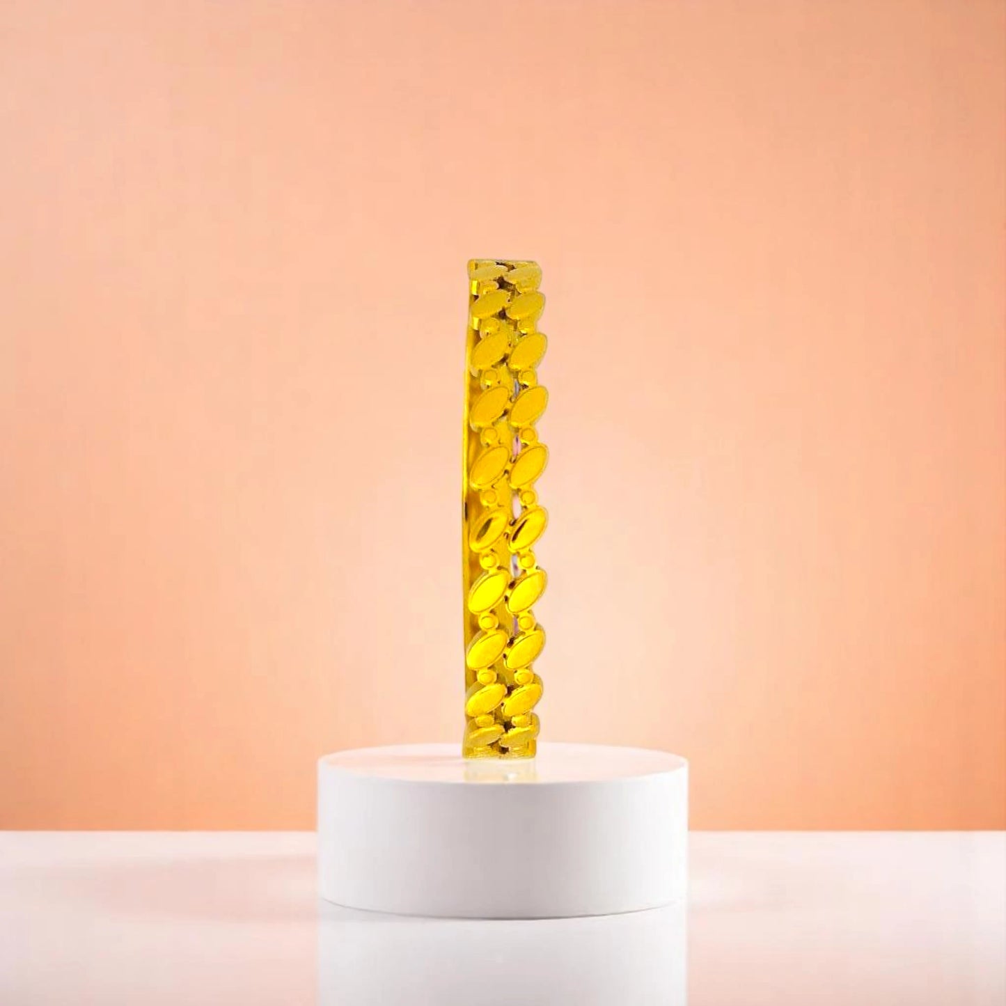 Bracelet on geometric prop with peach color gradient in the background.