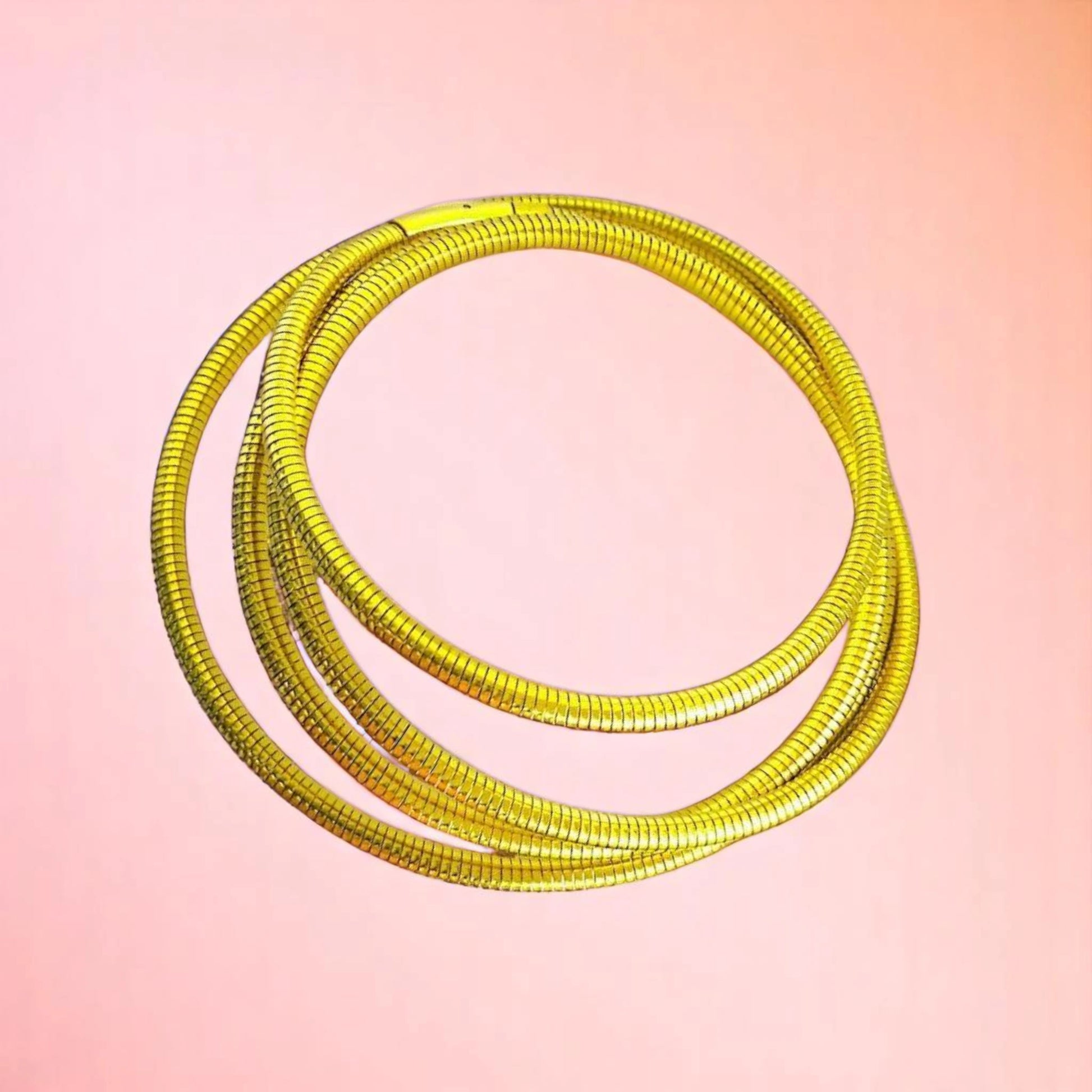 Bracelet on a color gradient of peach tones background.