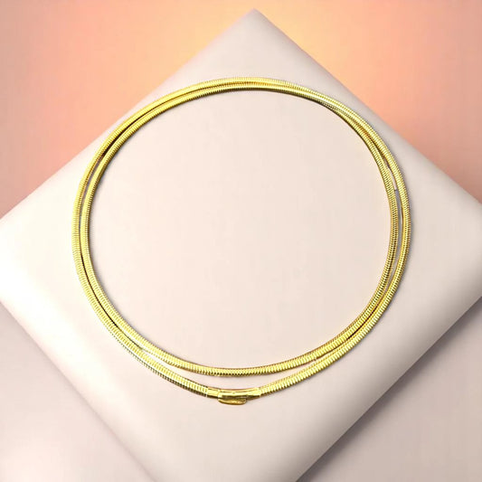 Bracelet on geometric prop with peach color gradient in the background.