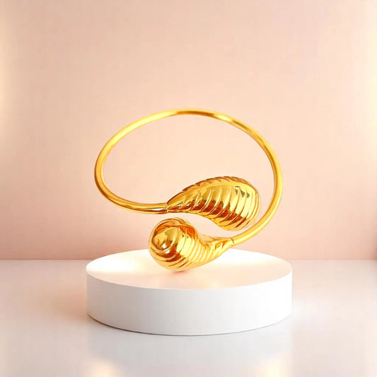 Bracelet on geometric prop with peach color gradient in the background.