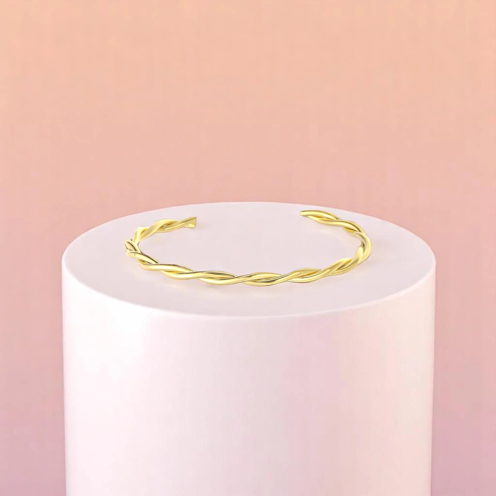 Bracelet on geometric prop with peach color gradient in the background.