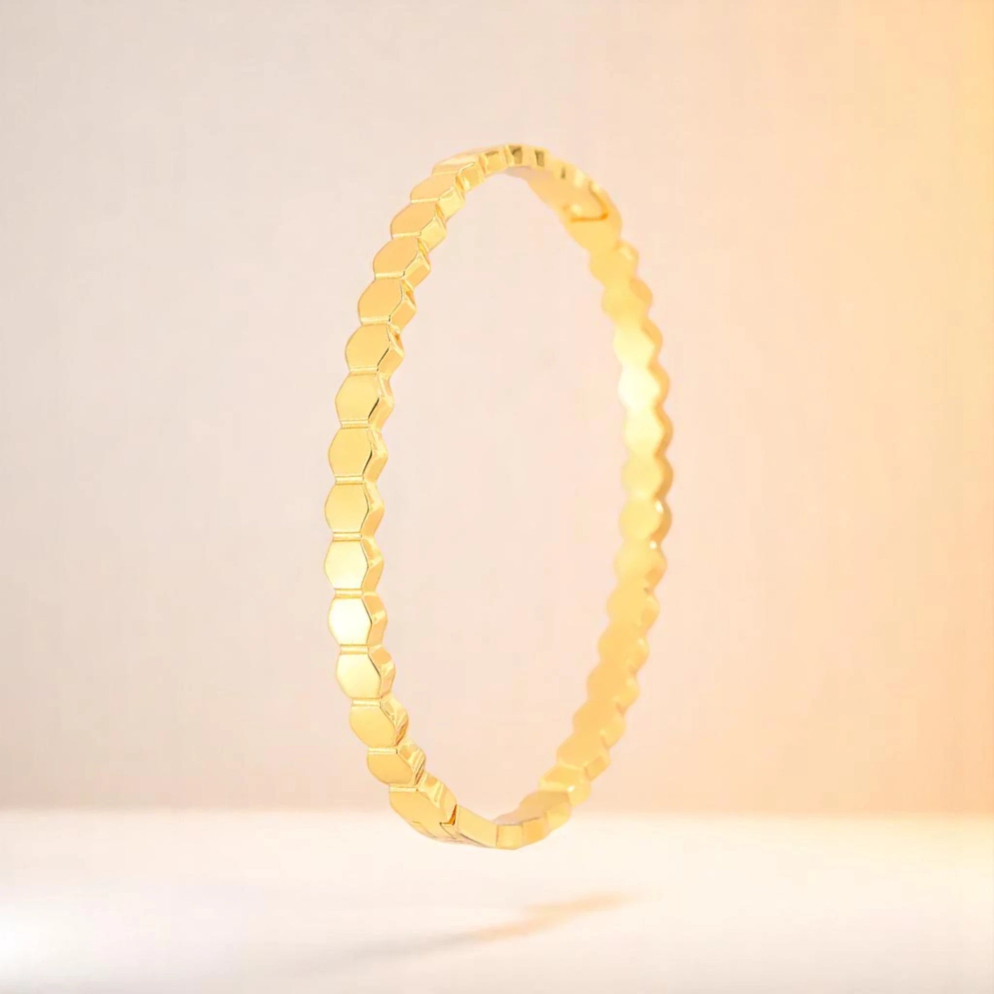 Bracelet on a color gradient of peach tones background.