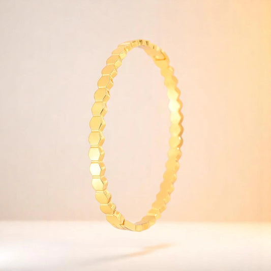 Bracelet on a color gradient of peach tones background.