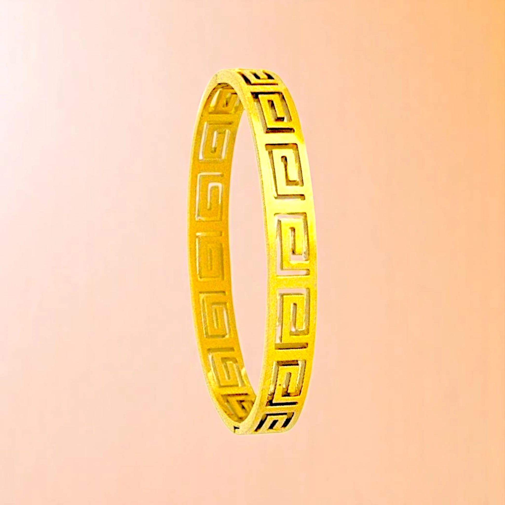 Bracelet on a color gradient of peach tones background.