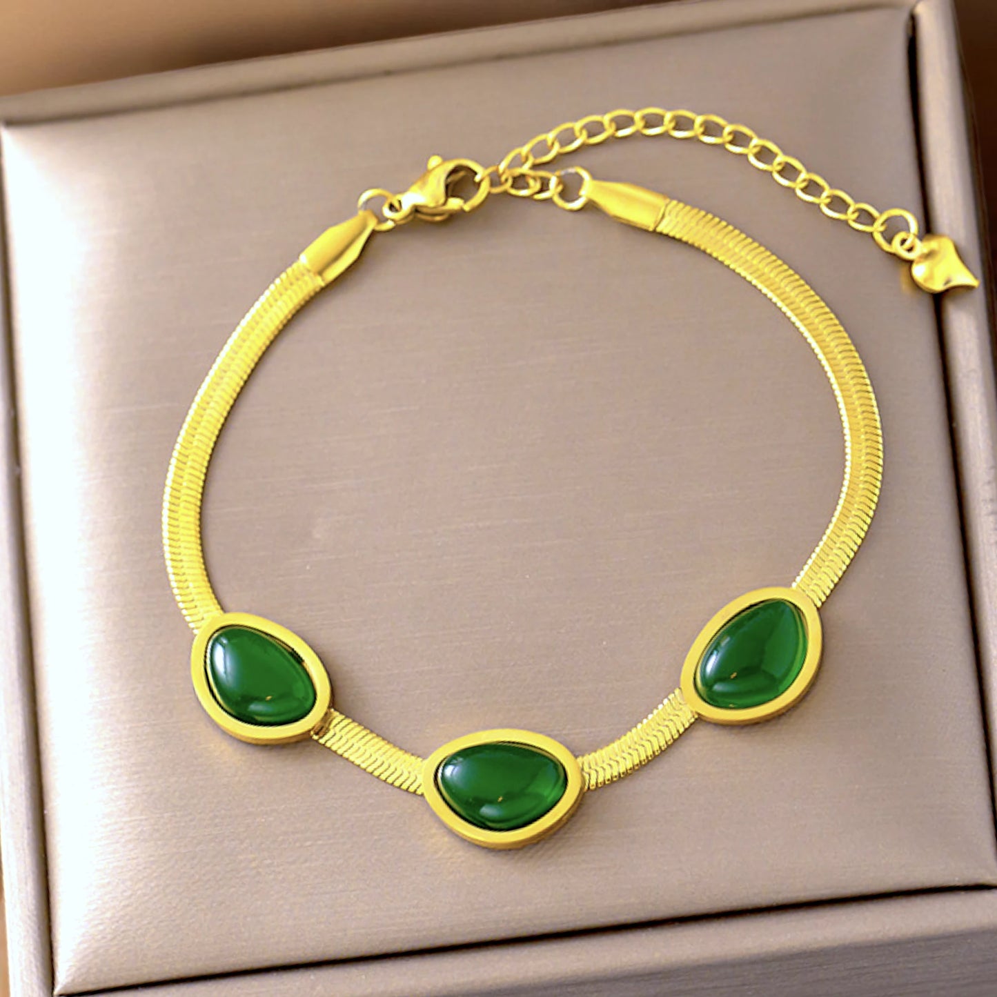 Bracelet on a soft fabric box with a light-toned background.