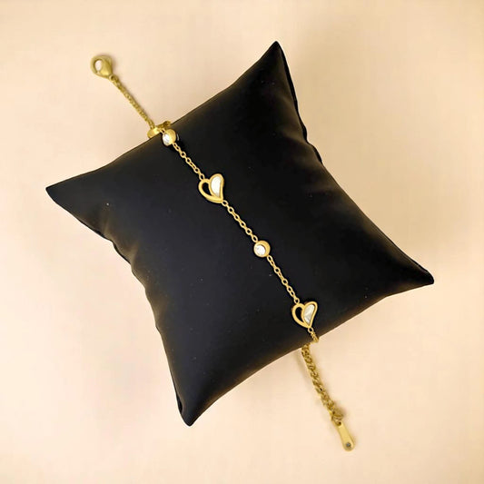 Bracelet rests elegantly on a black pillow against a neutral background.