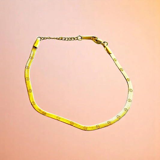Bracelet on a color gradient of peach tones background.