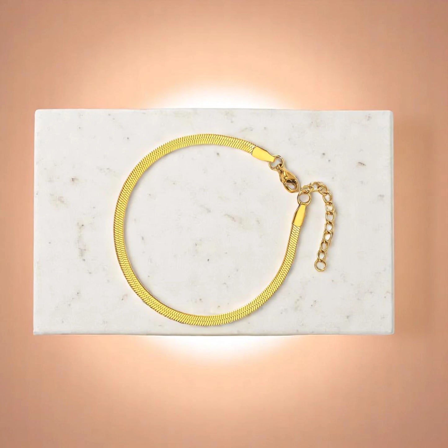 Bracelet on geometric prop with peach color gradient in the background.