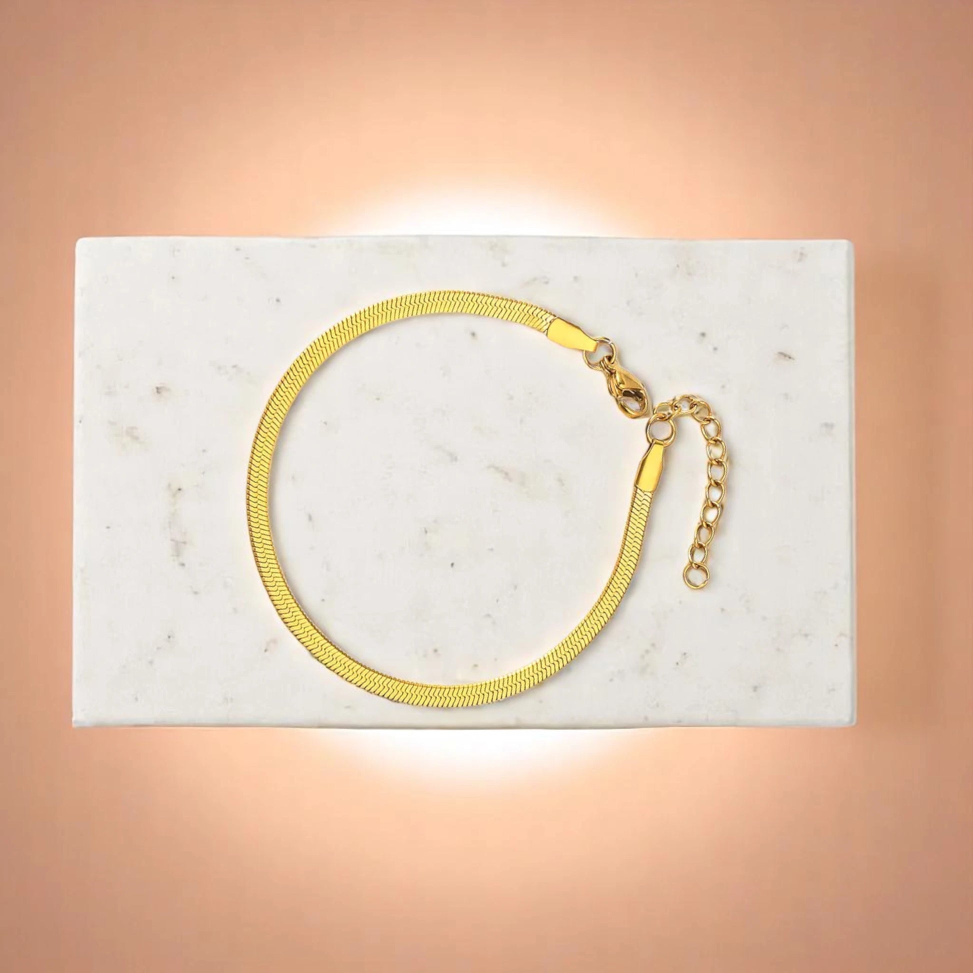 Bracelet on geometric prop with peach color gradient in the background.