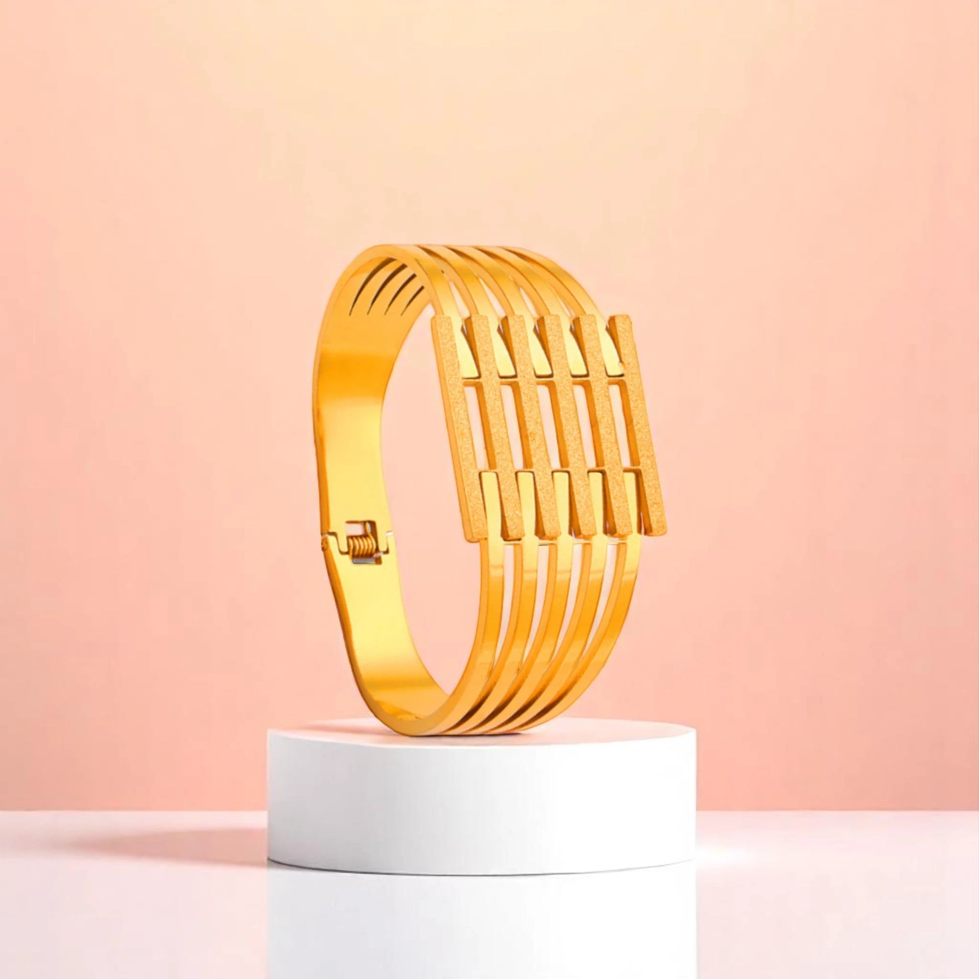 Bracelet on geometric prop with peach color gradient in the background.