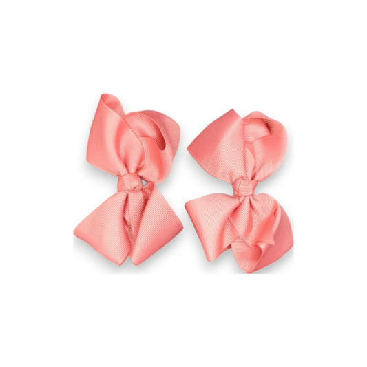 Two coral pink hair bows on a white background