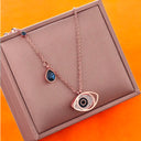 Midnight Grace | Rose Gold Evil Eye Necklace with Sapphire Accent