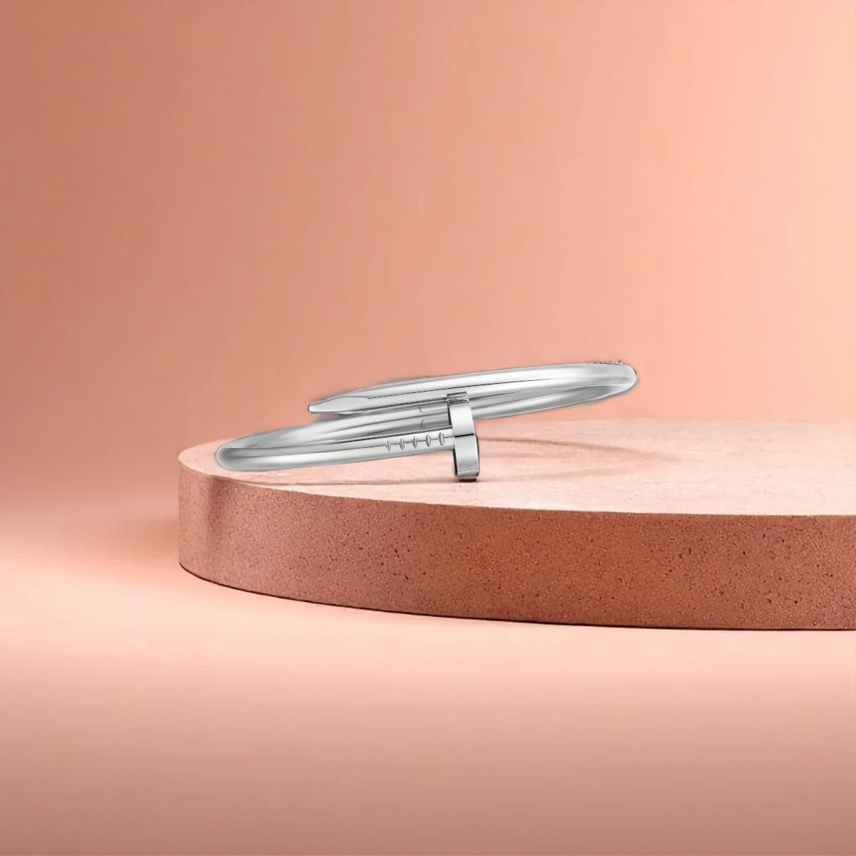 Bracelet displayed on a light-colored travertine stone slab with a peach-colored gradient in the background.