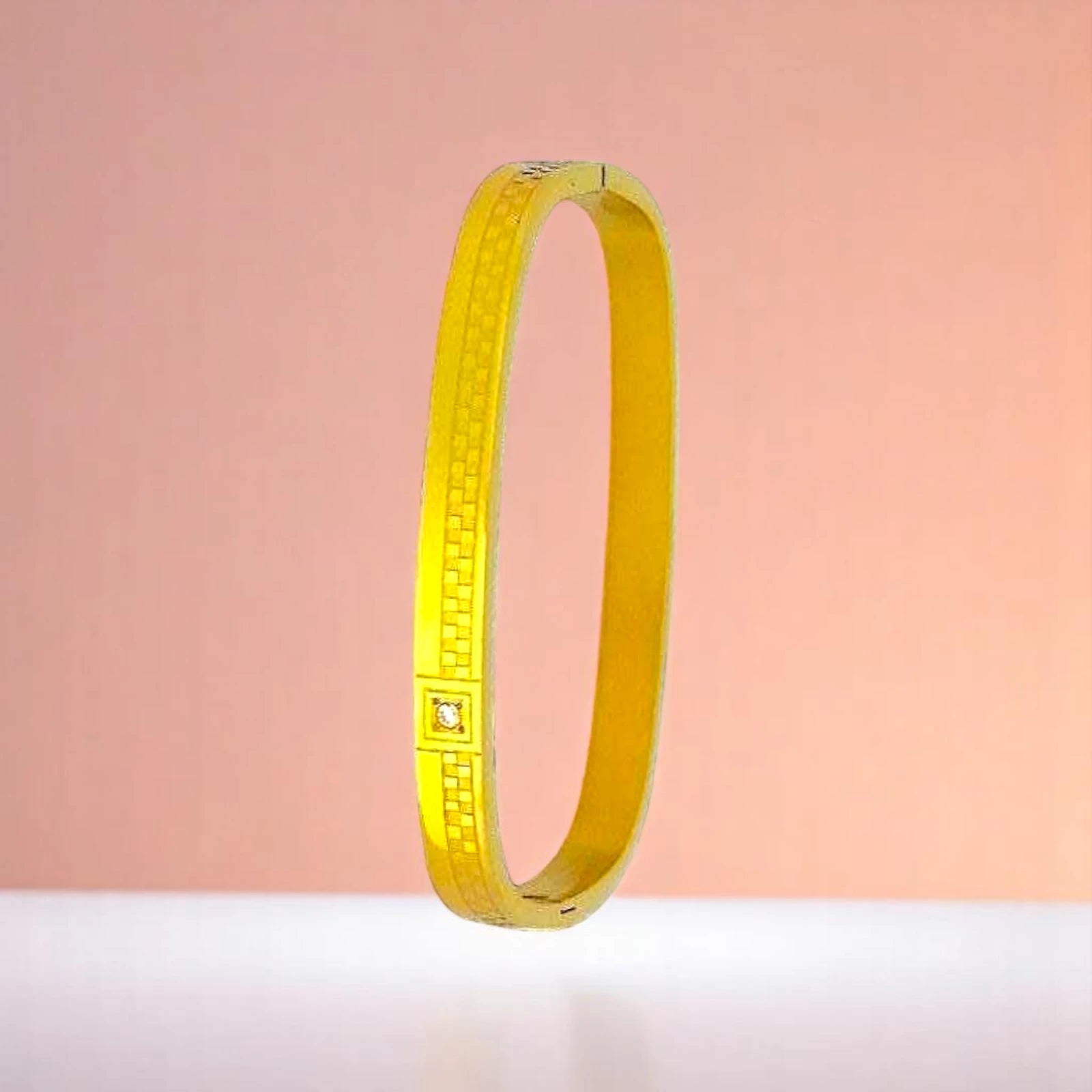 Bracelet on a color gradient of peach tones background.