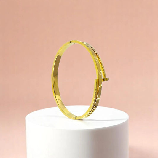 Bracelet on geometric prop with peach color gradient in the background.