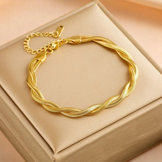 Bracelet on a soft fabric box with a light-toned background.