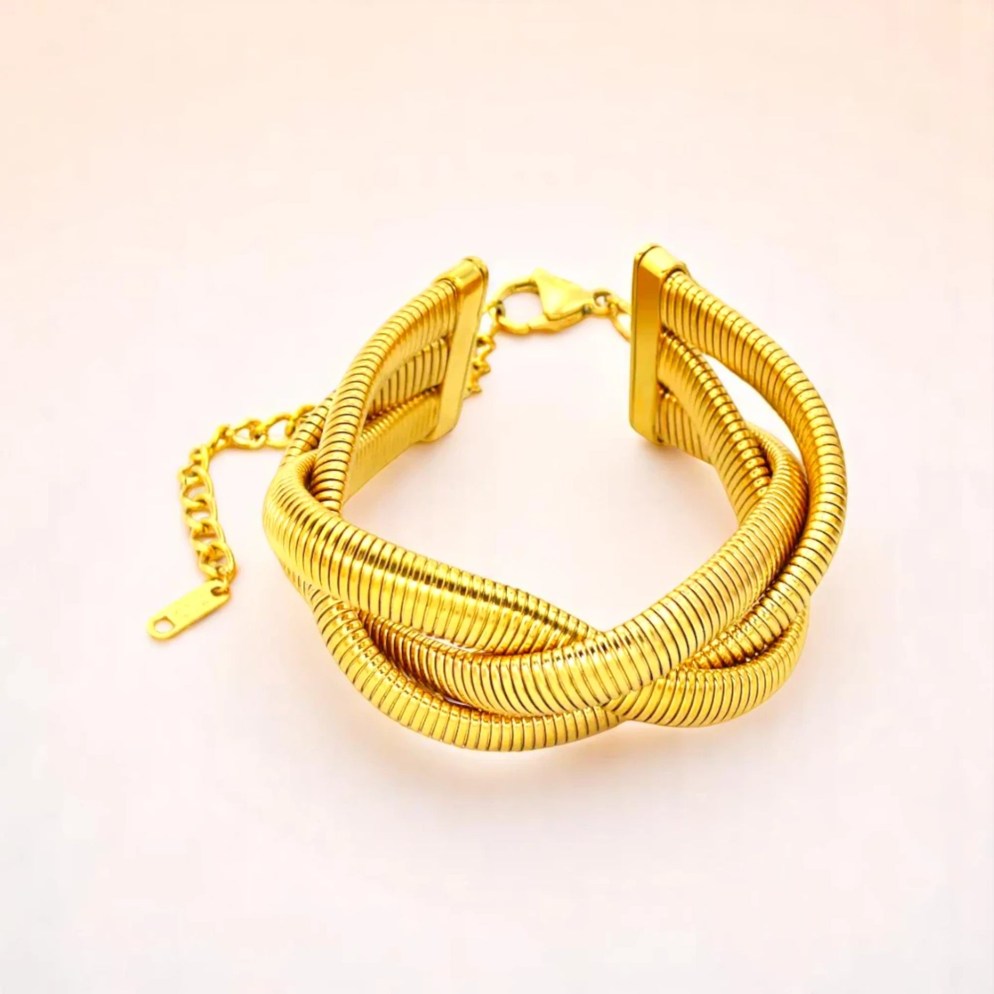 Bracelet on a color gradient of peach tones background.