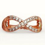 A rose gold infinity band ring set with clear cubic zirconia stones, shown on a clean white background.