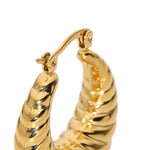 Close-up of a gold hoop earring with a twisted rope-like textured design and a butterfly clutch back, shown on a plain white background.