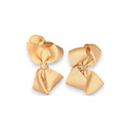 Two beige hair bows on a white background