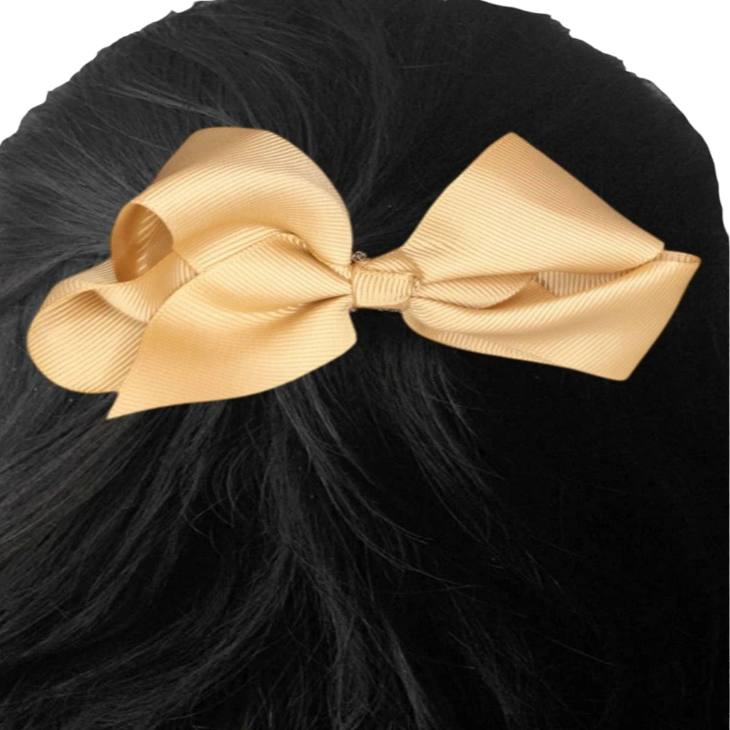 Beige bow on black hair