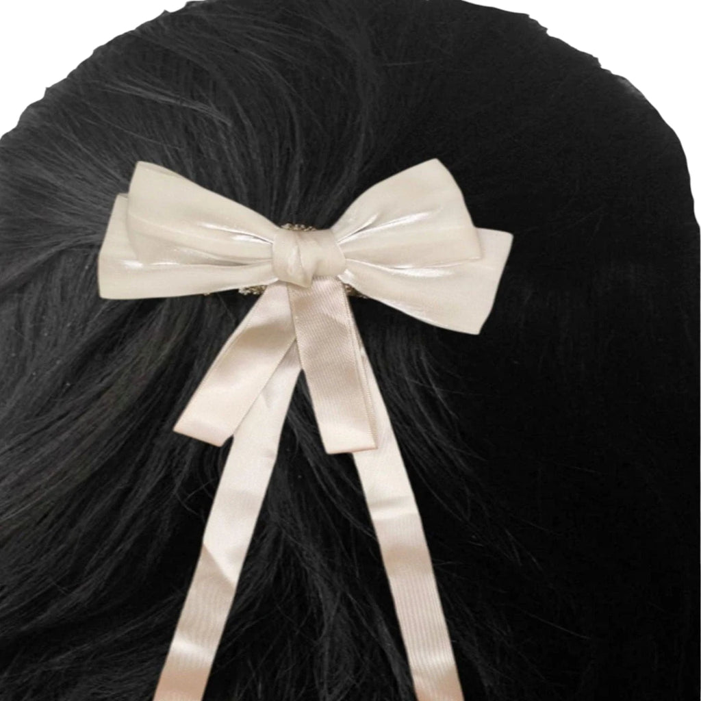 Beige bow hair clip on black hair