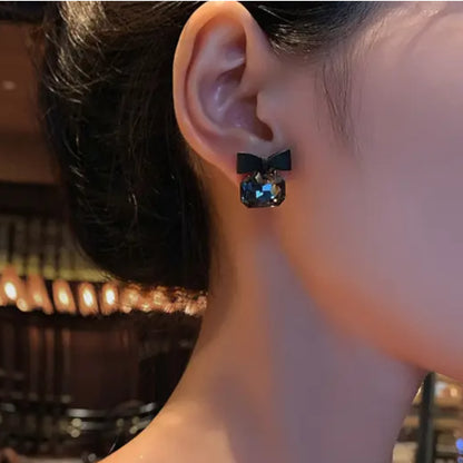 Black Bow Gemstone Stud Earrings worn by a model.