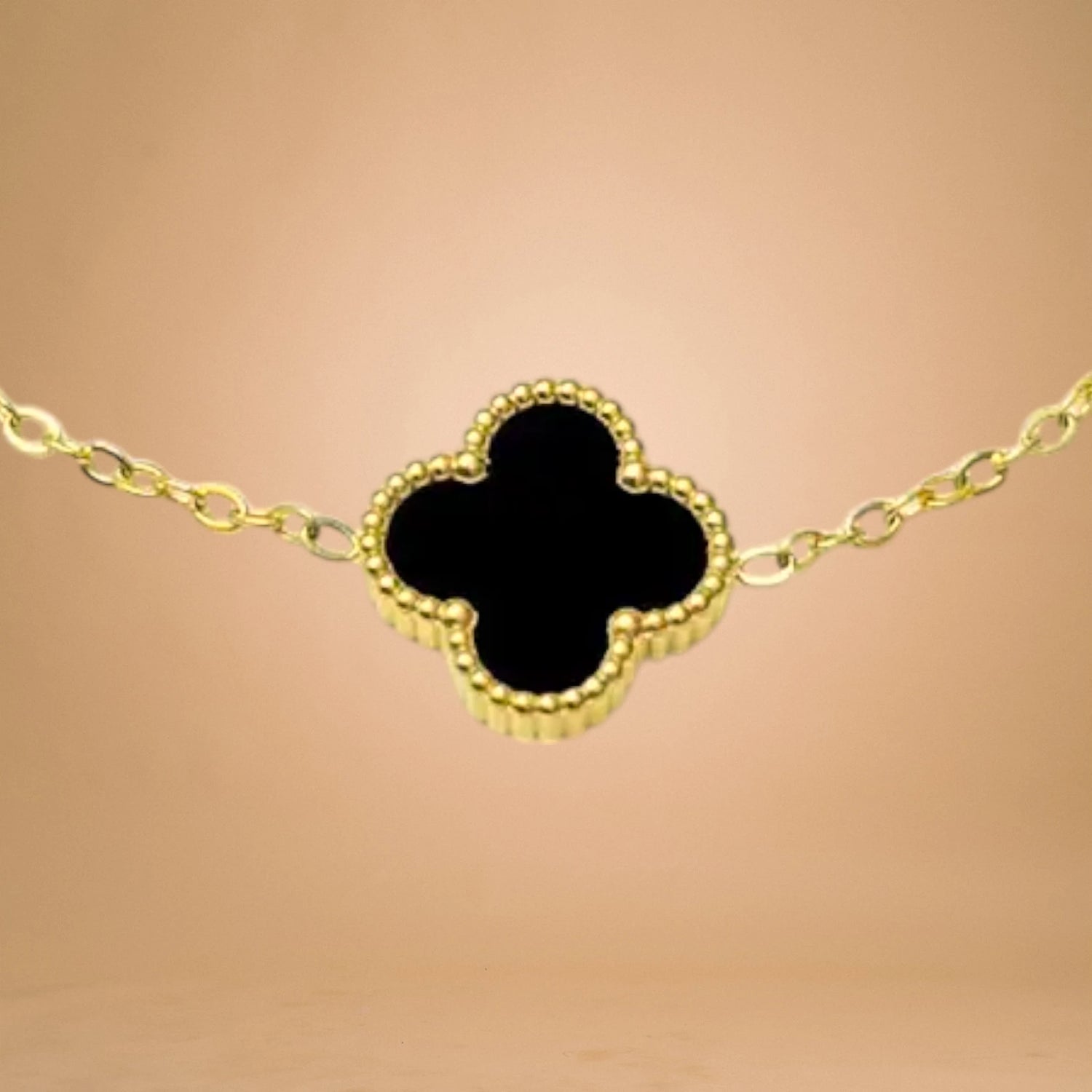 Bracelet zoom-in shot displayed on a peach-toned background.