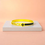 Bracelet displayed on a light-colored travertine stone slab with a peach-colored gradient in the background.