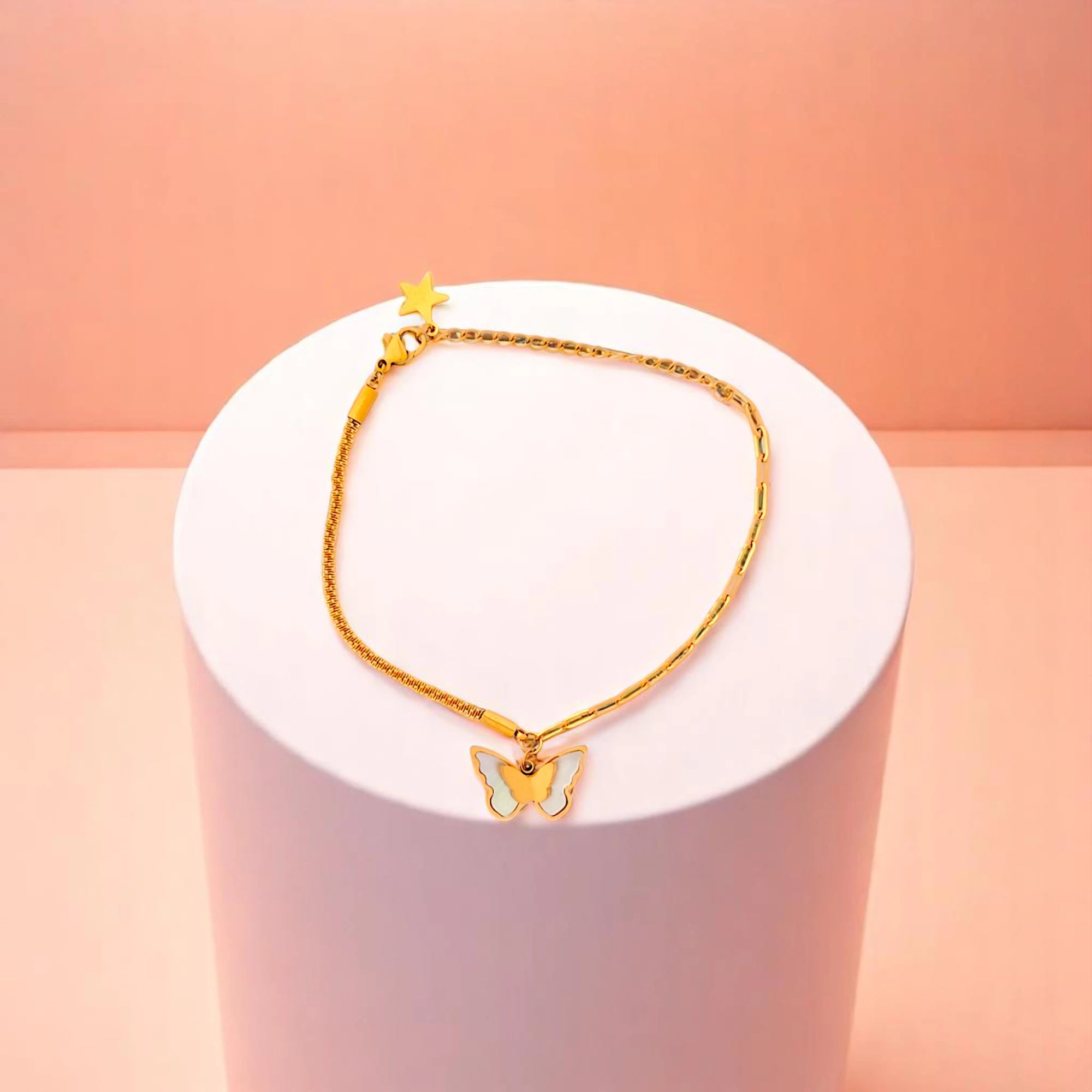 Bracelet on geometric prop with peach color gradient in the background.