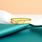 Bracelet set against a soft teal cloth background.